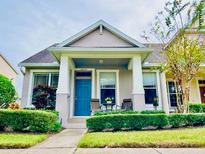 Charming Craftsman style home with a welcoming front porch and landscaping at 14650 Sweet Acacia Dr, Orlando, FL 32828