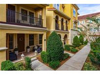 Inviting exterior of townhome with landscaped walkway and charming porch at 2321 Lobelia Dr, Lake Mary, FL 32746