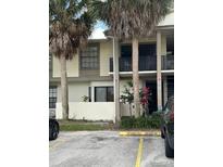 Condo building with palm trees and parking lot in front at 6008 Village Cir # Ge, Orlando, FL 32822