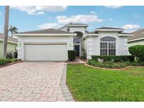 One-story home with a two-car garage and landscaped yard at 235 Royal Palm Dr, Davenport, FL 33837