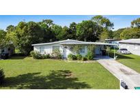 Cute ranch home with carport, spacious yard, and nicely landscaped front at 2816 Paine Ln, Orlando, FL 32826