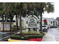 Entrance to Destiny Springs Condominiums with lush landscaping and parking at 934 Lake Destiny Rd # D, Altamonte Springs, FL 32714