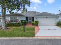 House exterior with light blue walls, white garage door and landscaping at 1551 Lake Marion Dr, Apopka, FL 32712