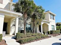 Two-story townhome with palm trees and well-manicured landscaping at 3053 Gatsby St, Kissimmee, FL 34746