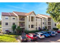 Two-story condo building with ample parking and landscaping at 3012 Parkway Blvd # 102, Kissimmee, FL 34747