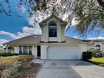 White two-story house with a two-car garage and landscaping at 751 Birgham Pl, Lake Mary, FL 32746