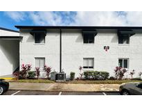Condo building exterior with landscaping and parking at 4407 S Semoran Blvd # 2, Orlando, FL 32822