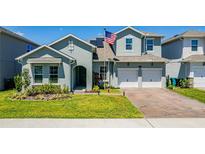 Two story house with a two car garage and a nicely landscaped lawn at 18357 Mowry Ct, Orlando, FL 32827