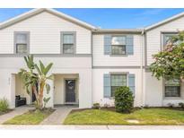 Two-story townhome with gray siding and blue shutters at 2412 Dubai St, Kissimmee, FL 34747