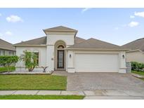 One-story house with a two-car garage, landscaping, and a paved driveway at 4001 Scarlet Branch Rd, Orlando, FL 32824