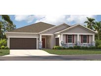 One-story home with brown garage door, stone accents, and landscaped yard at 12789 Trovita Dr, Grand Island, FL 32735