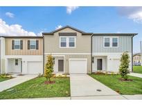 Modern townhome with two-car garage and landscaping at 246 Mandovi St, Davenport, FL 33837