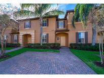 Townhouse exterior with brick driveway and landscaping at 3520 Calabria Ave # 3520, Davenport, FL 33897