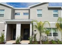 Modern two-story townhome with palm trees at 1144 Challenge Dr, Davenport, FL 33896