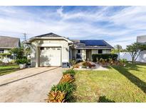 House exterior with a garage and solar panels at 2691 Winchester Cir, Eustis, FL 32726