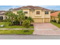 Two-story house with tile roof and three-car garage at 2760 Rialto Ct, Kissimmee, FL 34746