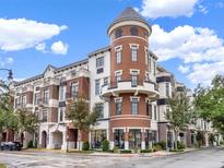 Brick building with a turret, balconies, and ground floor retail at 101 S New York Ave # 302, Winter Park, FL 32789