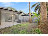 Private backyard with screened patio and tropical landscaping at 1308 Eagle Ln, Winter Garden, FL 34787