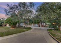 Long driveway leading to a charming house nestled amongst lush trees at 205 Elaine Pl, Chuluota, FL 32766