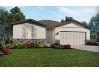 One-story home with a two-car garage, landscaping, and stone accents at 2106 Rosewood Dr, Bartow, FL 33830