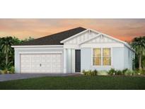 One story home with light blue exterior and two car garage at 5565 Flame Vine Way, Saint Cloud, FL 34771