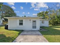 Cute one-story home with a screened front door and small front yard at 5514 Riordan Way, Orlando, FL 32808