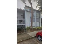 Condo building exterior with a palm tree and parking at 2546 Lemon Tree Ln # 4, Orlando, FL 32839