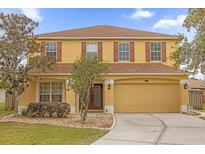 Two-story house with yellow exterior and brown roof at 1161 Cathcart Cir, Sanford, FL 32771