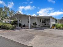 Charming single-story home with covered carport and landscaping at 905 Polo Park Blvd, Davenport, FL 33897