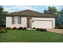 One-story home with a two-car garage, landscaping, and gray shutters at 375 Birkdale Dr, Daytona Beach, FL 32124