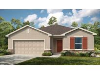 Exterior view of a single-story home with a two-car garage and landscaping at 638 Teviot Rd, Haines City, FL 33844
