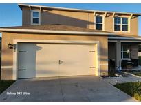 Two-story house with attached garage and landscaping at 2582 Glacier Express Ln, Tavares, FL 32778