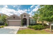 One-story home with attached garage and well-manicured landscaping at 5160 Oakbourne Ave, Davenport, FL 33837