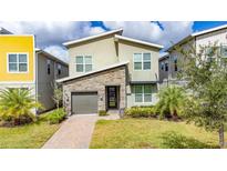Modern two-story home with stone accents and a two-car garage at 2770 Bookmark Dr, Kissimmee, FL 34746