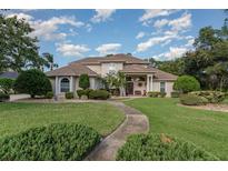 Two story home with landscaped lawn at 36 Allenwood Look, Ormond Beach, FL 32174