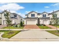 Two story townhome with two car garage and brick paver driveway at 1174 Seaside Mist Trl, Kissimmee, FL 34747