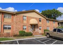 Brick building exterior with entrance and parking at 404 Banyon Tree Cir # 200, Maitland, FL 32751