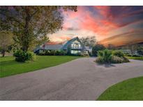 A-frame house exterior at sunset, long driveway at 4150 Citrus St, Kissimmee, FL 34746