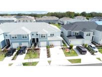 Aerial view of townhouses with two-car garages and landscaped yards at 4778 Sparkling Shell Ave, Kissimmee, FL 34746