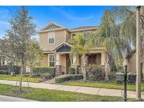Two-story house with a front porch, landscaping, and mailbox at 15121 Pigeon Plum Ln, Winter Garden, FL 34787