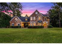 Two-story house with stone and stucco exterior at dusk at 8407 River Branch Pl, Sanford, FL 32771