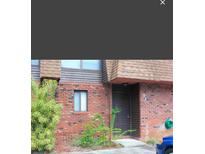 Brick building exterior with a brown door and landscaping at 1836 N Crystal Lake Dr # 31, Lakeland, FL 33801