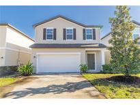 Two-story house with a white garage door and landscaping at 2076 Cades Cove Way, Deland, FL 32720