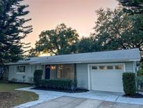 Updated single-story home with gray siding, attached garage, and well-manicured lawn at 924 Beard Ave, Winter Park, FL 32789