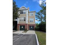 Tan three-story building with two-car garages at 13103 Mulberry Park Dr # 817, Orlando, FL 32821