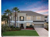 Two-story house with a three-car garage and palm trees in the front yard at 1435 Myrtle Oaks Trl, Oviedo, FL 32765