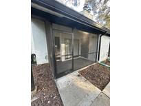 Screened porch with a concrete floor and wood chip ground cover at 174 Waterfall Way # 106, Altamonte Springs, FL 32714