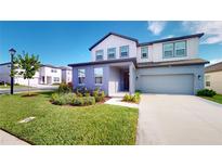 Two-story home with gray siding and a two car garage at 2277 Derwent Dr, Davenport, FL 33896