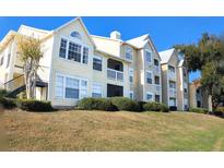 Tan colored multi-unit building with grassy lawn at 1065 S Hiawassee Rd # 1428, Orlando, FL 32835