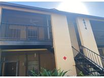 Building exterior with stairs and screened balcony at 4814 S Semoran Blvd # 407, Orlando, FL 32822